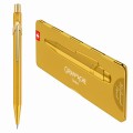 Złoty ołówek automatyczny Caran d’Ache 844 Goldbar obok dopasowanego złotego etui Slimpack.